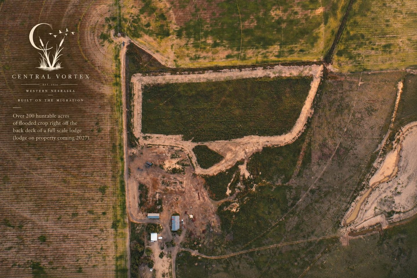 Aerial view of the Central Vortex Outfitters property near Bridgeport, Nebraska, showing flooded crop ground behind the lodge site